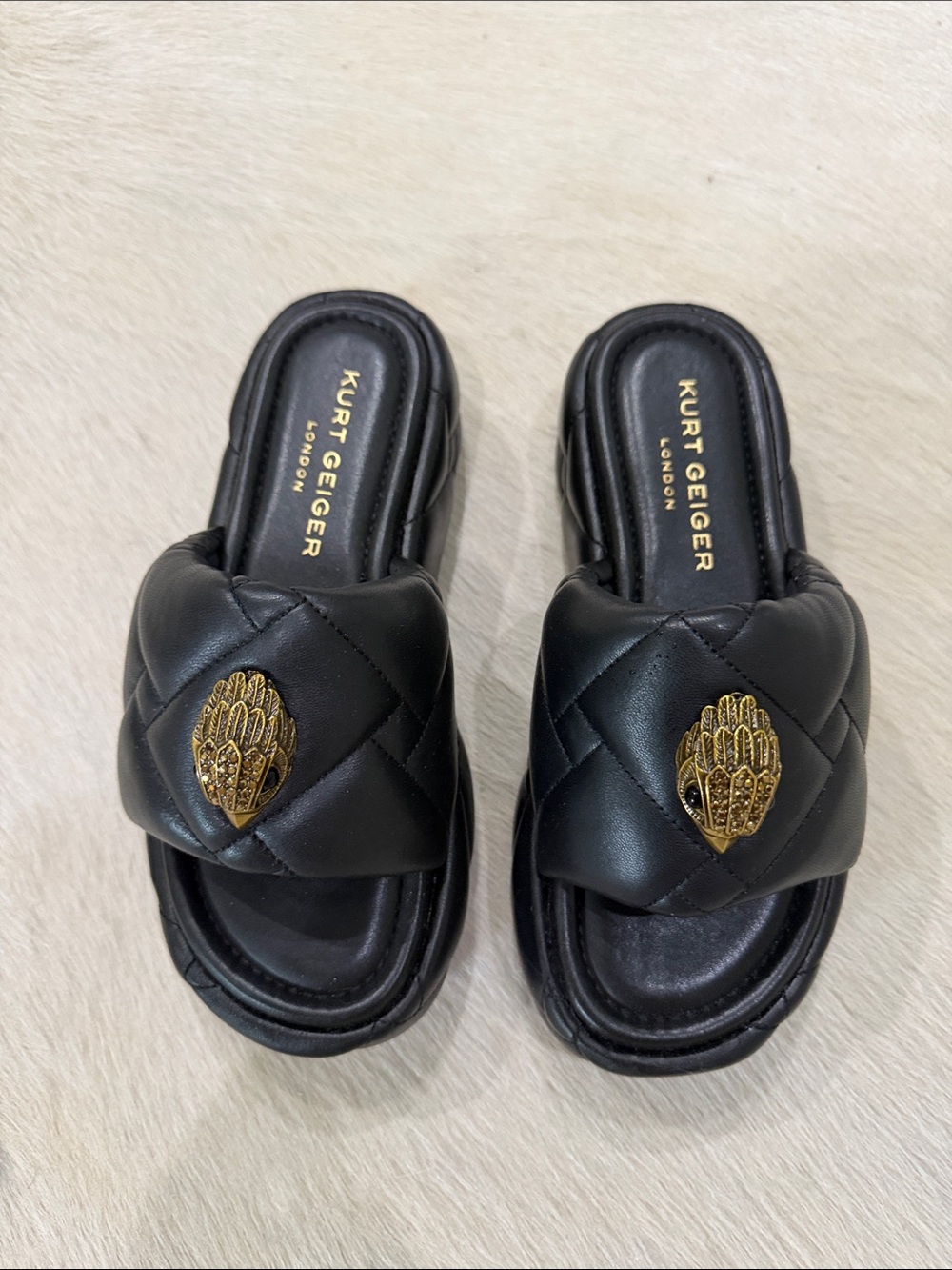 Kurt Geiger Black Quilted Slide Mules with Gold Hand Emblems